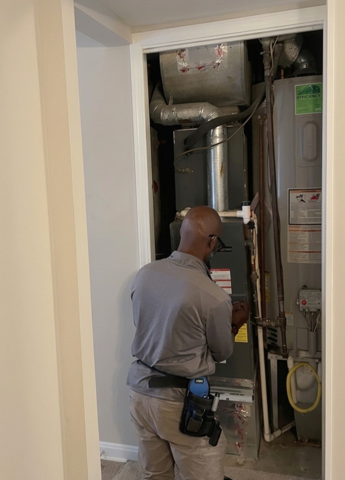 Chris Lynn evaluating residential HVAC equipment during a home inspection